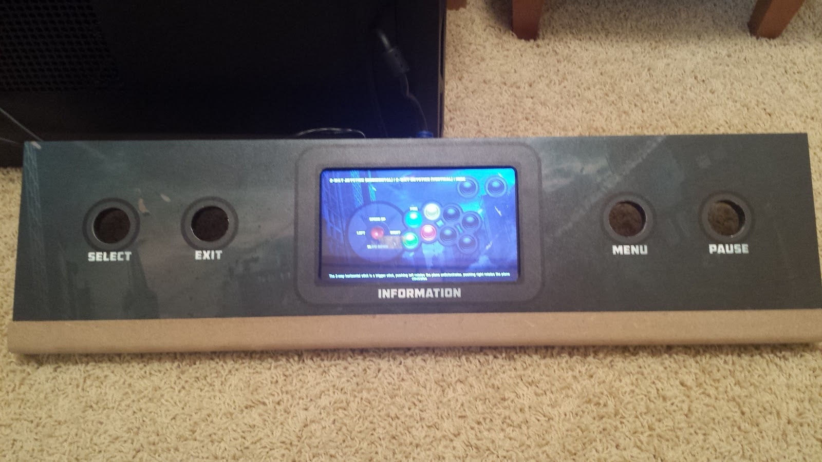 Administration panel with unpainted bottom trim piece attached. The screen in the center is lit, showing a sample arcade game control scheme.